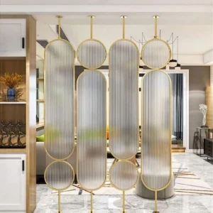 Anat Aurora decorative freestanding room partition set with gold stainless steel frames forming vertical ovals and circles filled with semi-transparent fluted/ribbed glass. Luxury divider available near Ambala, Haryana, and across India.Anat Aurora decorative freestanding room partition set with gold stainless steel frames forming vertical ovals and circles filled with semi-transparent fluted/ribbed glass. Luxury divider available near Ambala, Haryana, and across India.