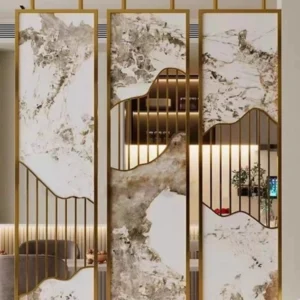 Anat Moka decorative freestanding room partition with three panels, featuring gold stainless steel frames and panels with abstract white/gray marble patterns and mirror cut-outs in a mountain-peak shape. Luxury divider available near Ambala, Haryana, and across India.