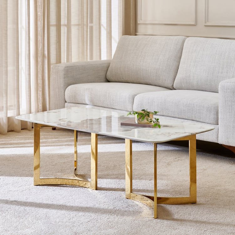 Anat White Haven Marble Coffee Table with Gold Base Anat White Haven rectangular coffee table featuring a white, gray, and gold veined marble top on a polished gold-finish metal geometric base. Luxury living room furniture available near Ambala, Haryana, and across India.