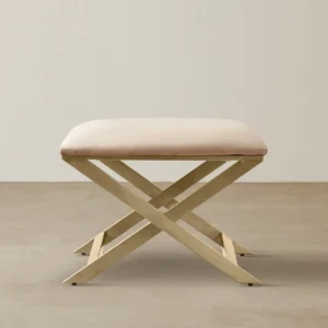 Anat Luxe Gold X Frame Ottoman featuring a cushioned velvet seat and golden cross-frame base, modern furniture in India.