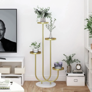 Anat Nova modern four-tiered indoor plant stand featuring a tall gold metal frame with a curved base design and four round display platforms at staggered heights, standing on a white marble base. Decorative furniture available near Ambala, Haryana, and across India.