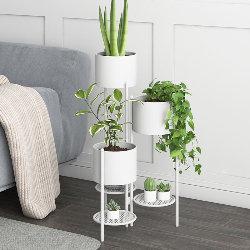 Anat Opulent Gold Plant Tower Anat Opulent modern triple-tiered plant stand featuring a tall gold metal frame with three integrated cylindrical gold planter pots and two lower round grid shelves. Decorative furniture available near Ambala, Haryana, and across India.