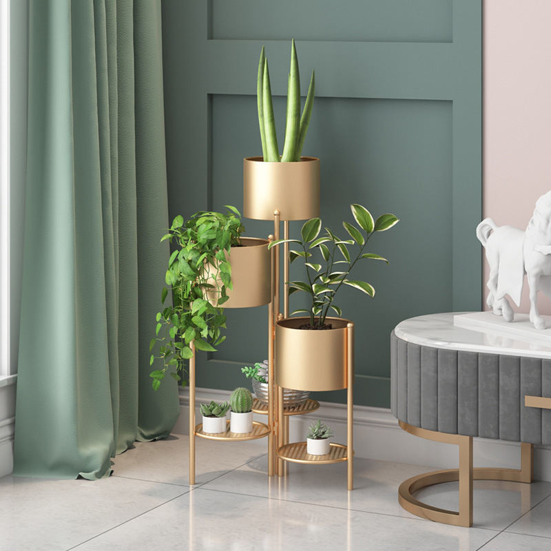 Anat Opulent Gold Plant TowerAnat Opulent Gold Plant Tower Anat Opulent modern triple-tiered plant stand featuring a tall gold metal frame with three integrated cylindrical gold planter pots and two lower round grid shelves. Decorative furniture available near Ambala, Haryana, and across India.